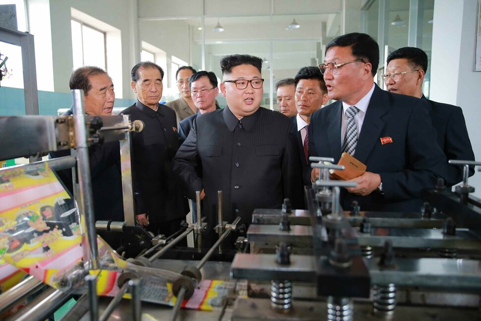 North Korean leader Kim Jong-un observes a factory operated by disabled military veterans