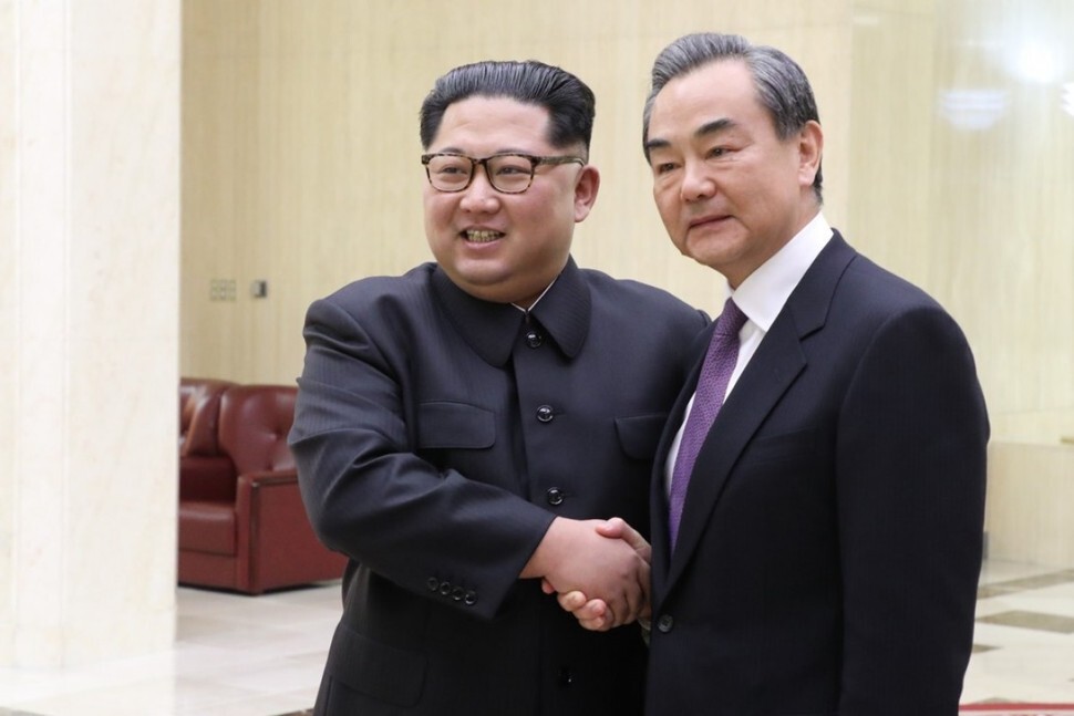 Chinese Foreign Minister Wang Yi shakes hands with North Korean leader in Pyongyang on May 3