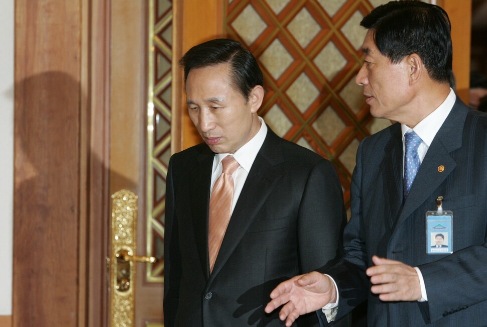 Former President Lee Myung-bak speaks with then-Minister of the Interior and Safety