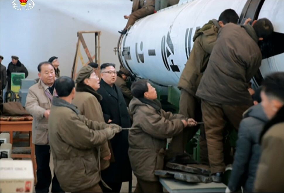 North Korean leader Kim Jong-un and General Ri Pyong-chol (far left) watch preparation for the launch of the Pukguksong-2 ballistic missile