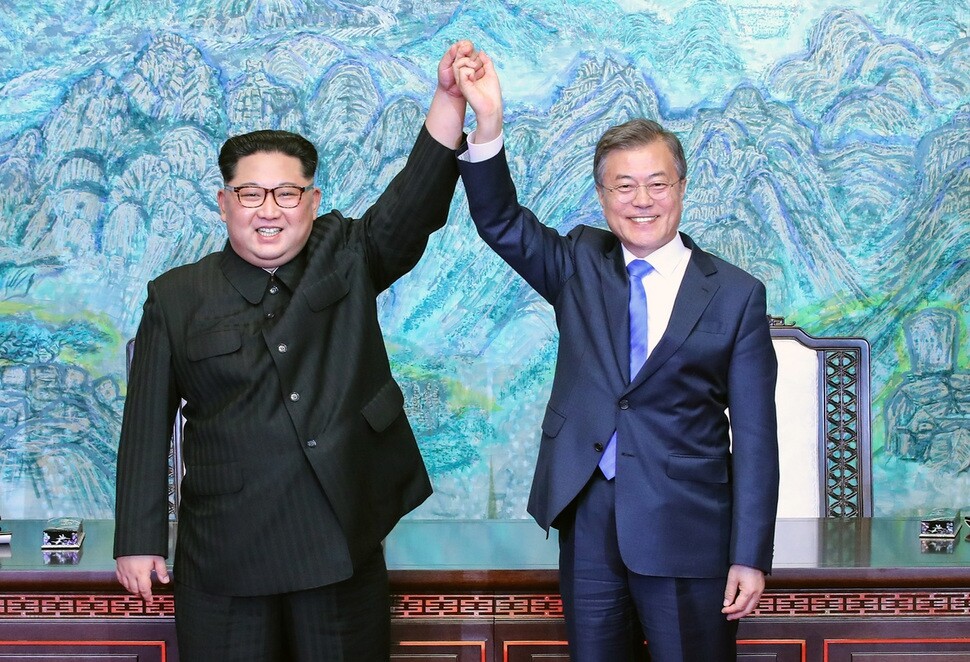 South Korean President Moon Jae-in and North Korean leader Kim Jong-un hold up their hands after signing the Panmunjeom Declaration for Peace