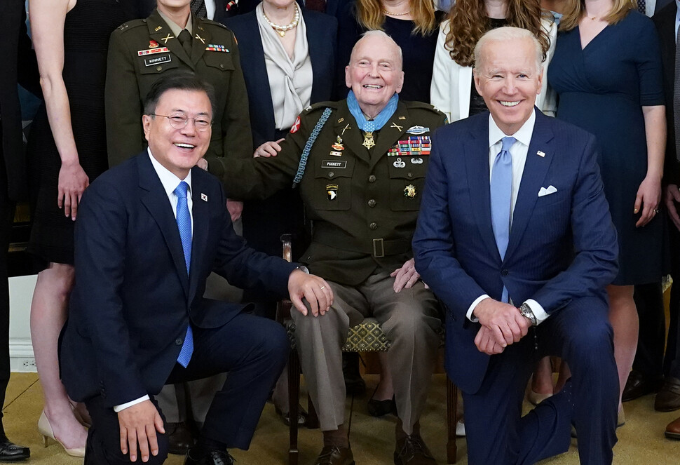 2021년 5월21일 미국 워싱턴 백악관에서 한-미 정상회담을 한 문재인 대통령(왼쪽)과 조 바이든 미국 대통령(오른쪽)이 한국전쟁 참전 군인 명예훈장을 받은 랠프 퍼켓 주니어 예비역 대령 가족과 기념사진을 찍고 있다. 연합뉴스