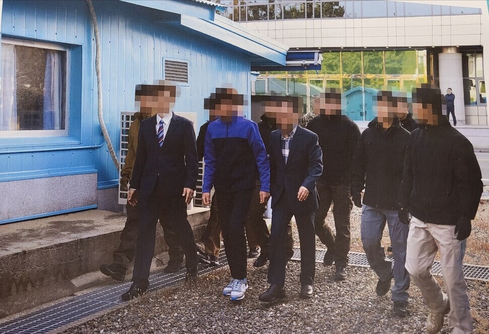 On July 12, 2022, the Ministry of Unification released the above photo along with others that had been taken on Nov. 11, 2019, of the repatriation of two fishers to North Korea. The individual in tennis shoes and blue and black jacket is one of the fishers. (provided by the MOU)