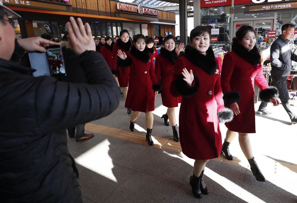 Members of the North Korean cheerleading group wave to South Korean citizens during their stop at a rest area in Gapyeong