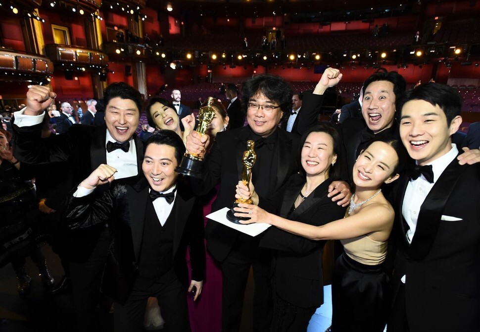 South Korean filmmaker Bong Joon-ho accepts the prize for best screenplay at the 2020 Academy Awards in Los Angeles on Feb. 9.