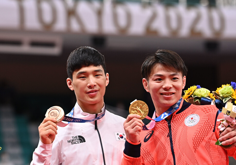 ポール・アン（左）は、25東京/オリンピック写真財団で日本の日本武道館で開催された男子66kg柔道イベントで銅メダルを獲得した後、日本の金メダリストの阿部久美とポーズをとる