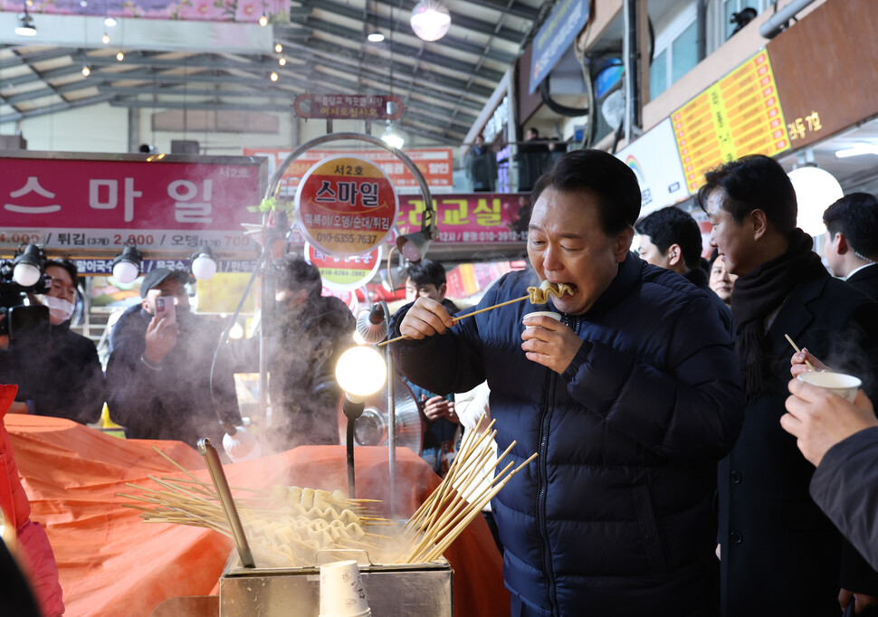 윤석열 대통령이 25일 경기도 의정부시 의정부제일시장을 찾아 어묵을 먹고 있다.<BR> 연합뉴스