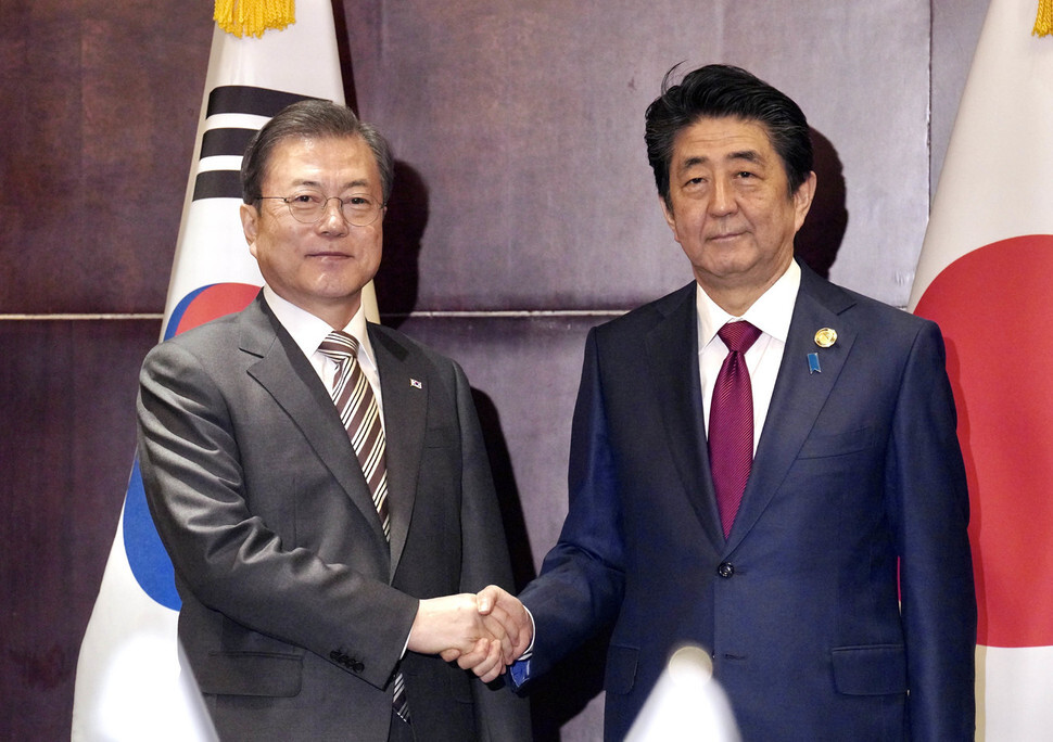 South Korean President Moon Jae-in shakes hands with Japanese Prime Minister Shinzo Abe ahead of their summit on the afternoon of Dec. 24 in Chengdu, Sichuan Province, China.