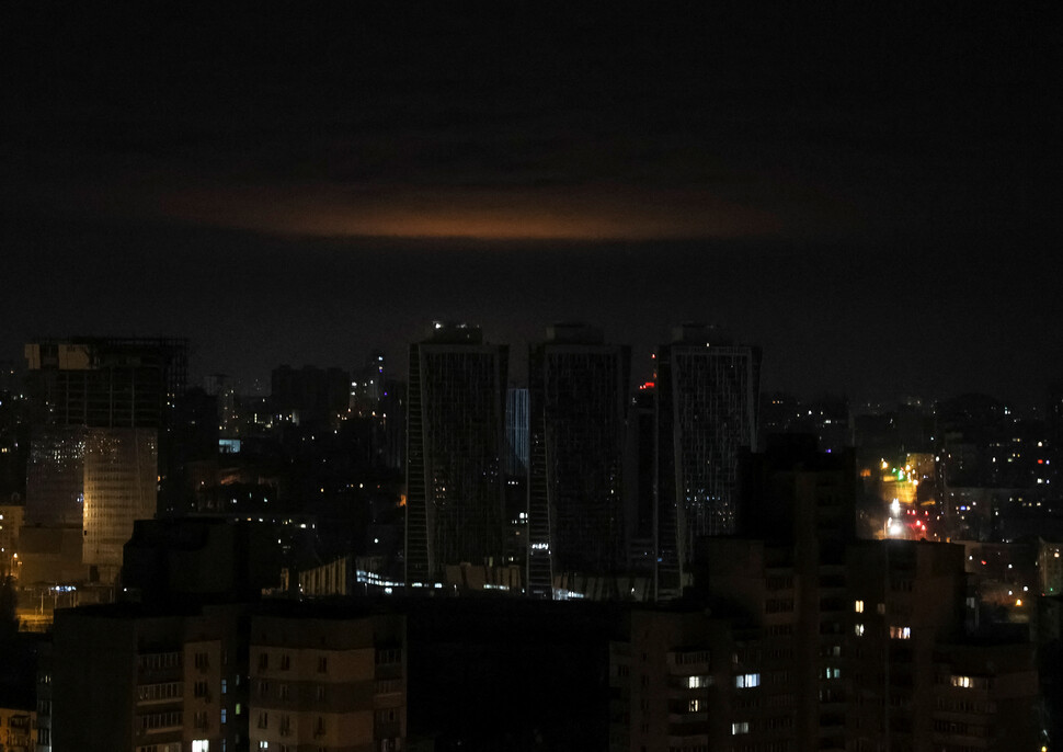 2023년 1월1일 새벽(현지시각) 러시아군이 우크라이나 수도 키이우를 자폭 드론과 미사일로 공격하면서 어둠에 잠긴 스카이라인 위로 섬광이 비치고 있다. REUTERS 연합뉴스
