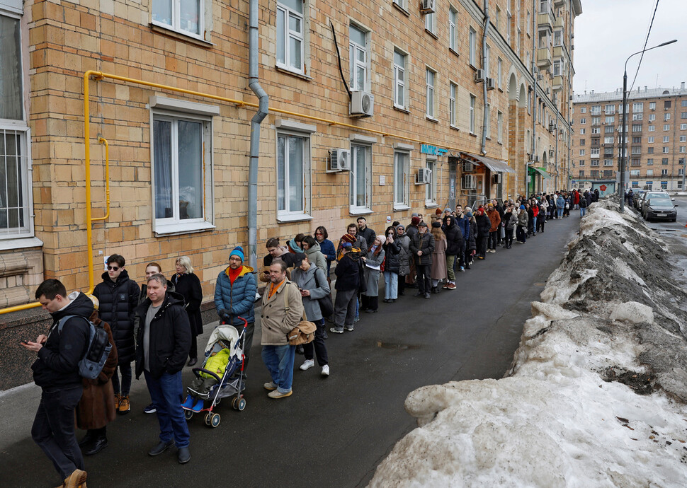 ‘푸틴에 반대하는 정오.’ 러시아 대선 마지막 날인 2024년 3월17일 낮 12시께 수도 모스크바의 투표소 앞에서 갑자기 불어난 유권자들이 길게 줄을 늘어서 있다. REUTERS