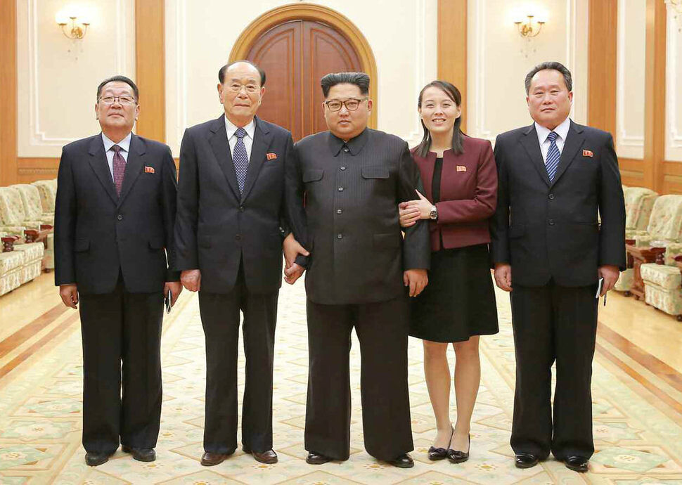 North Korean leader Kim Jong-un poses for a commemorative photo with members of the high-ranking delegation to South Korea upon their return to Pyongyang on Feb. 11. From left are Choe Hwi