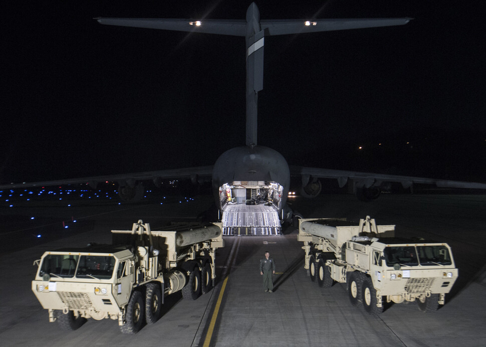 A C-17 Globemaster aircraft delivers two vehicles for launching interceptor missiles