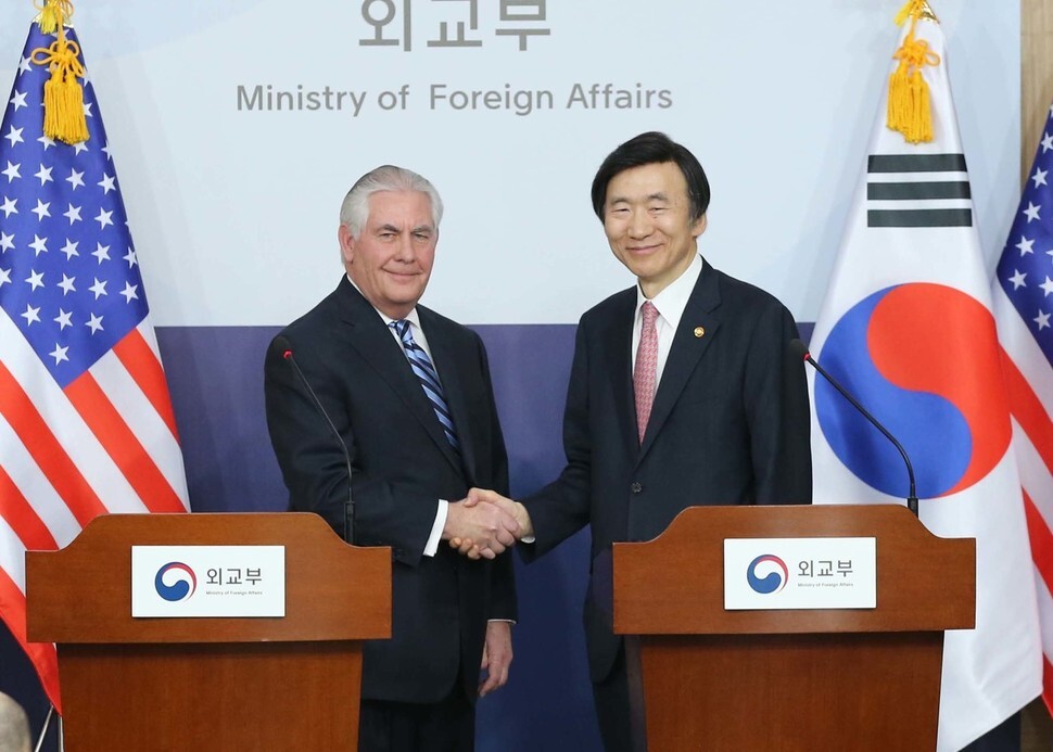 South Korean Foreign Minister Yun Byung-se shakes hands with US Secretary of State Rex Tillerson after a joint press conference at the Central Government Complex in Seoul