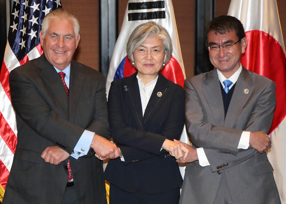 South Korean Minister of Foreign Affairs Kang Kyung-wha (center) clasps hands with US Secretary of State Rex Tillerson and Japanese Foreign Minister Taro Kono at their meeting during the ASEAN Regional Forum in Manila
