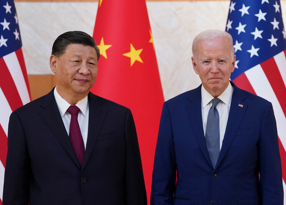 Chinese President Xi Jinping and US President Joe Biden stand for photos to mark their in-person summit in Bali, Indonesia, on Nov. 14. (Reuters/Yonhap)