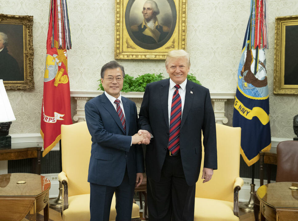 South Korean President Moon Jae-in shakes hands with US President Donald Trump in the White House’s Oval Office on May 22. (Blue House photo pool)