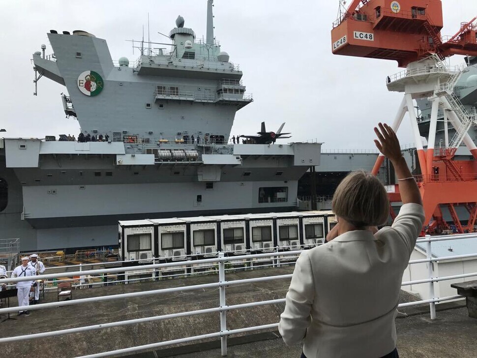 UK Ambassador to Japan Julia Longbottom waves at the HMS Queen Elizabeth as it arrives at Yokosuka Naval Base in Japan on Saturday. (Twitter screenshot)