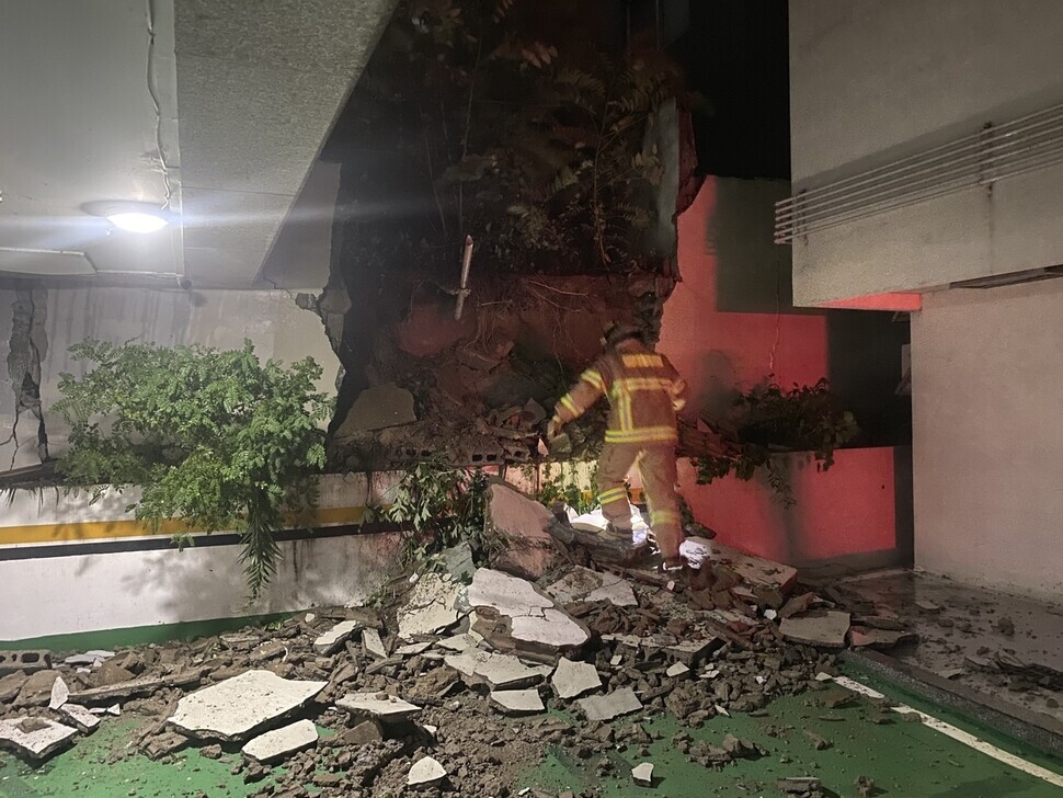 An emergency responder takes safety measures after the wall of a parking garage in Daegu’s Nam District collapses due to Typhoon Hinnamnor in the early hours of Sept. 6. (courtesy Daegu Fire & Safety Department)