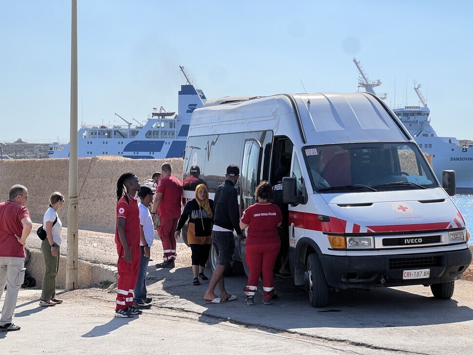 Migrants who arrived in Lampedusa’s Favaloro Pier board an ambulance to be taken to the island’s immigrant reception center on Oct. 4. (Noh Ji-won/The Hankyoreh)