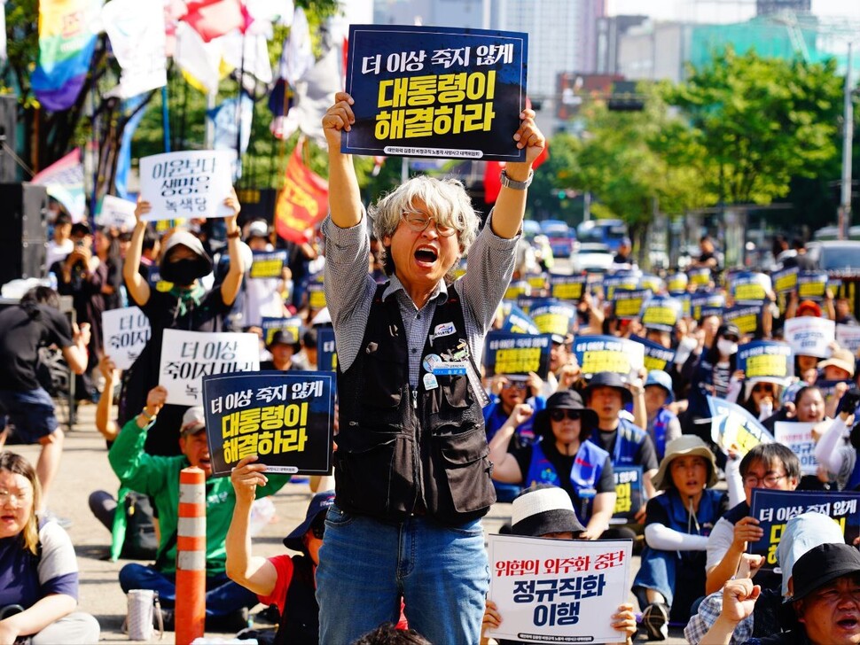 2025년 6월8일 선반 작업 중 회전체에 끼여 숨진 김충현(50)씨를 추모하는 자리에서 석탄화력발전소 비정규직 노동자 송상표씨가 자리에서 일어나 ‘더 이상 죽지 않게 대통령이 해결하라’ 손팻말을 높이 들고 구호를 외치고 있다. 태안화력김충현대책위 제공