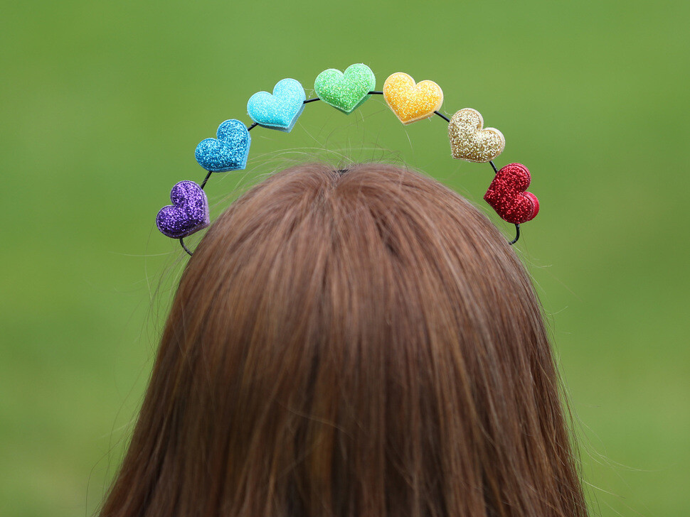 One participant in the Queer Culture Festival wears a headband with multicolored hearts