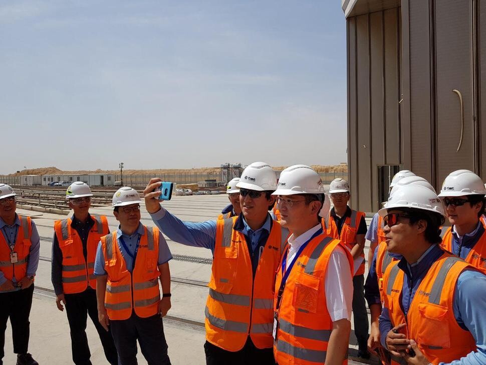 Samsung Electronics Vice Chairman Lee Jae-yong poses for a photograph with other Samsung executives at a Samsung C&T construction site in Riyadh