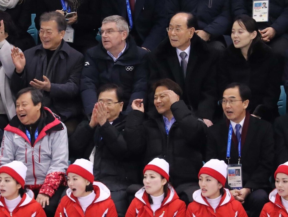 President Moon Jae-in (left) watches the first game of the unified Korean women’s hockey team with IOC President Thomas Bach