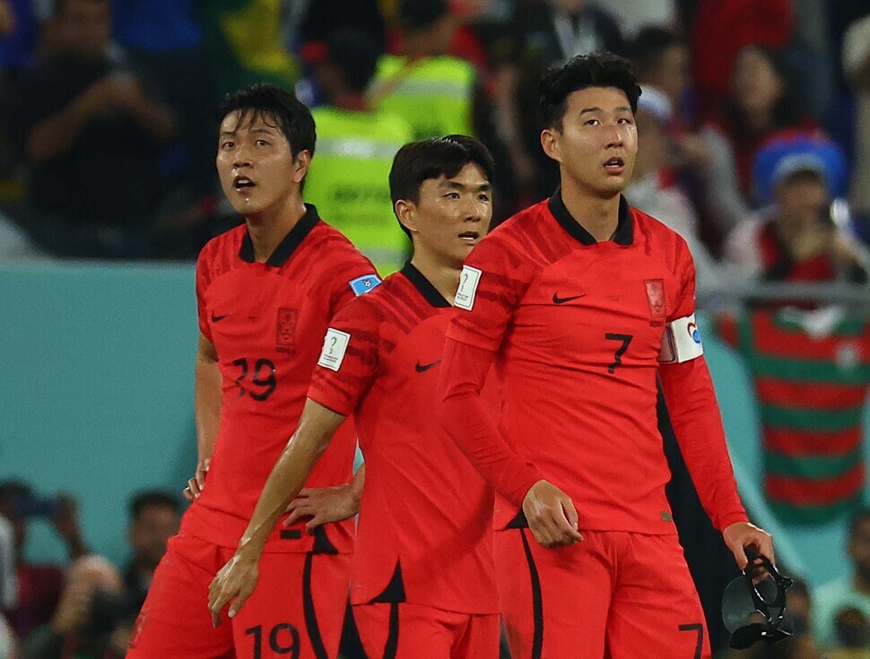 Korean players react after Brazil scores its third goal of their knockout round match on Dec. 5 (local time) at Stadium 974 in Doha, Qatar.