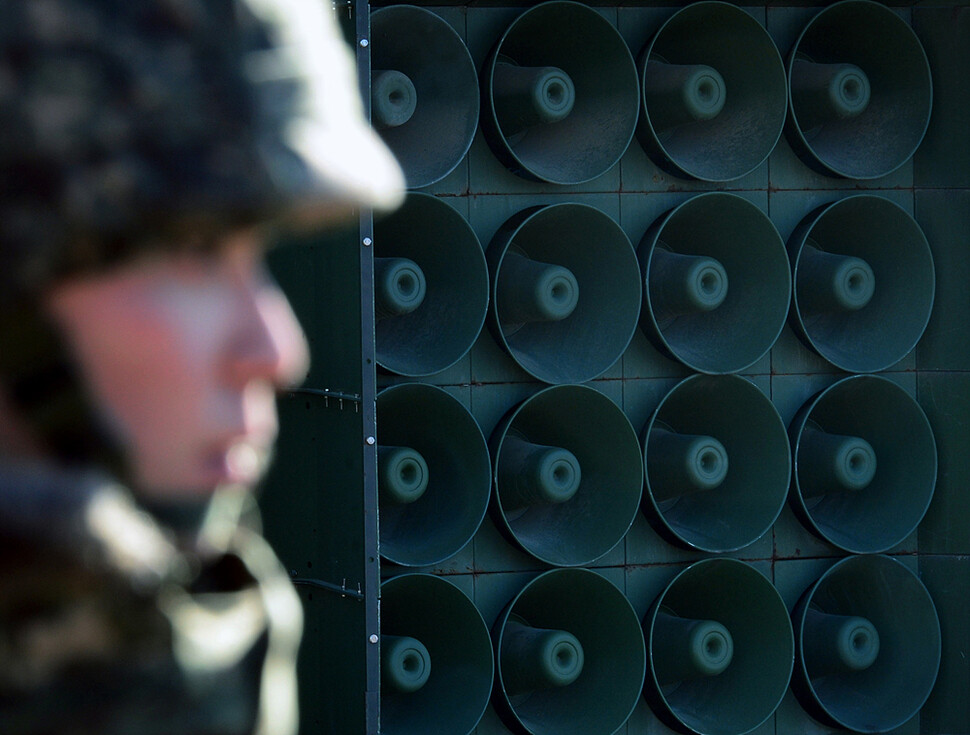 A soldier passes in front of loudspeakers near the southern part of the DMZ in Yeoncheon
