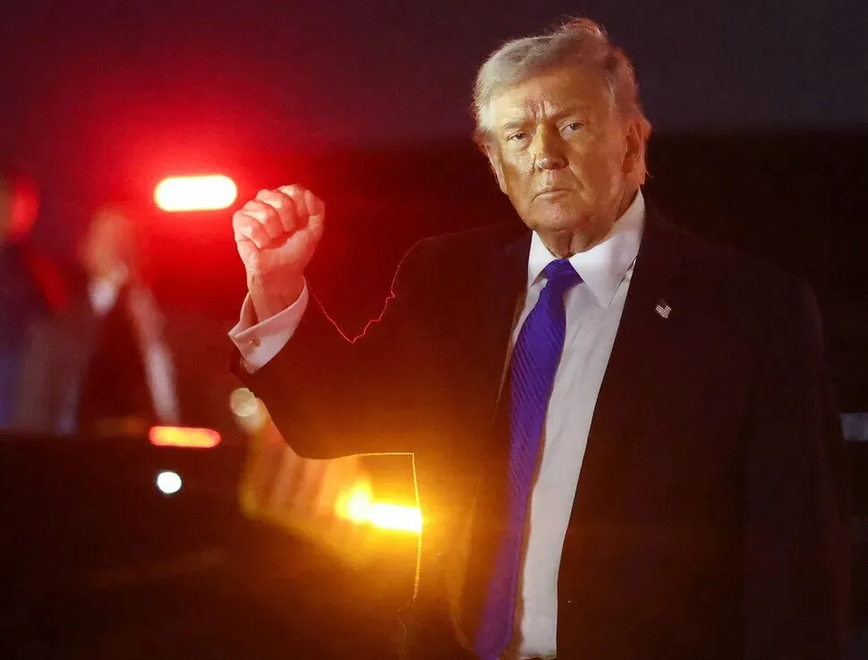 US President Donald Trump pumps his fist after stepping off Air Force One at Palm Beach International Airport on March 13, 2026. (Reuters/Yonhap)