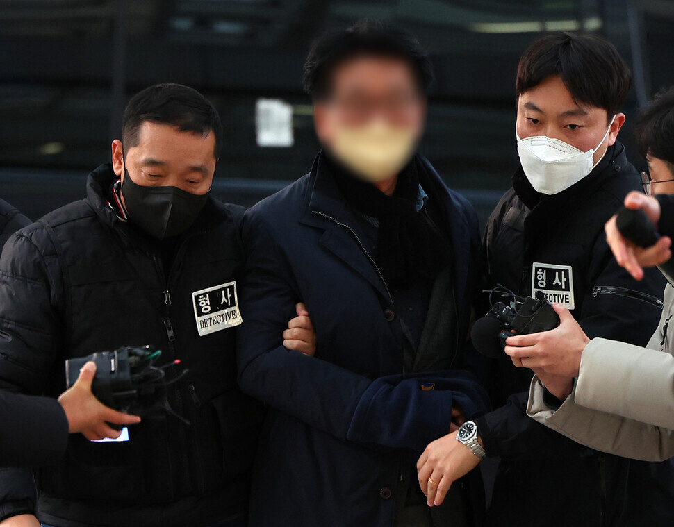 The individual suspected of stabbing Democratic Party leader Lee Jae-myung, identified by the surname Kim, is taken to the Busan Metropolitan Police Agency in the southeastern port city’s Yeonje District. (Yonhap)