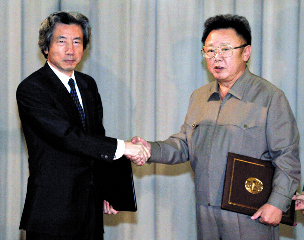 On Sept. 17, 2002, North Korean leader Kim Jong-il and Japanese Prime Minister Junichiro Koizumi shake hands after adopting the Pyongyang Declaration. (pool photo)