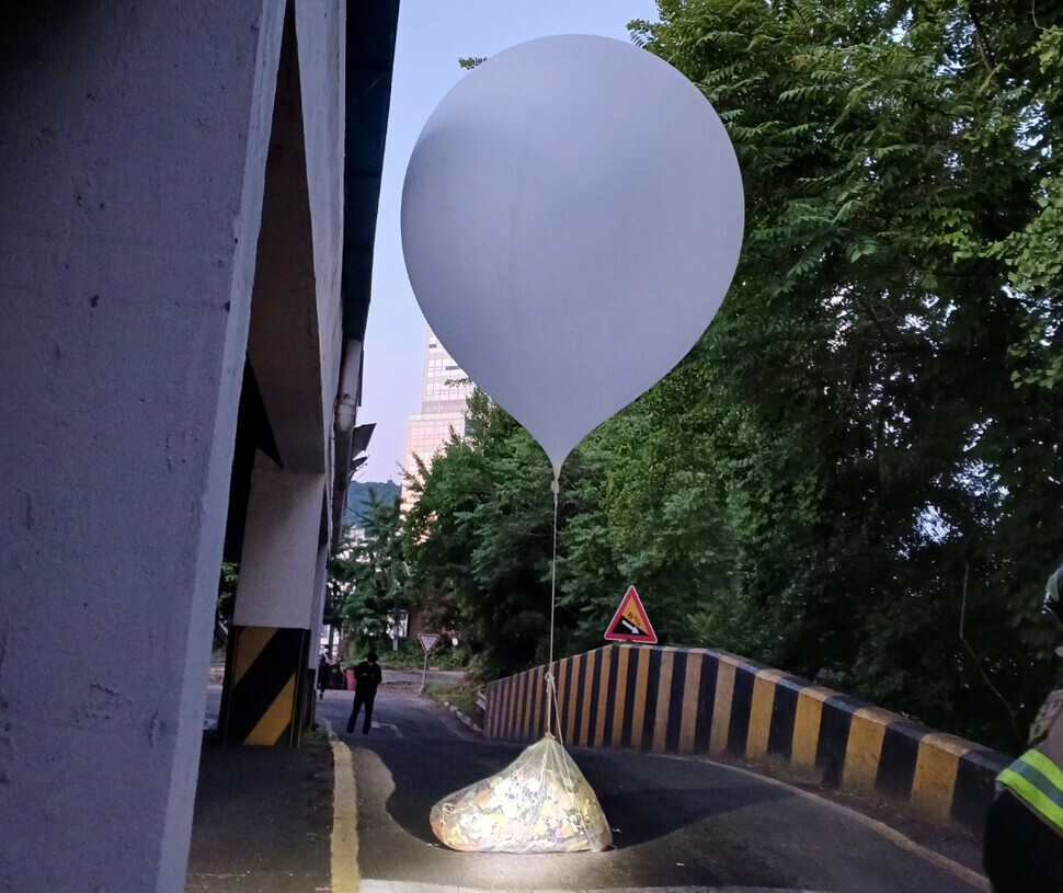 A balloon carrying a bag of trash flown by North Korea to South Korea landed on a road in Incheon’s Michuhol District on June 2, 2024. (courtesy of Incheon Fire Services)