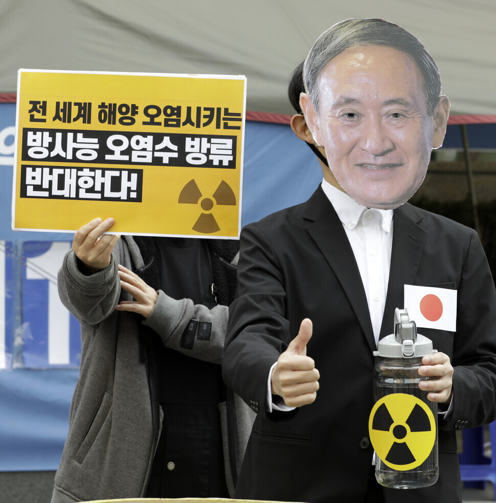 A demonstrator mocks Japanese Prime Minister Yoshihide Suga.